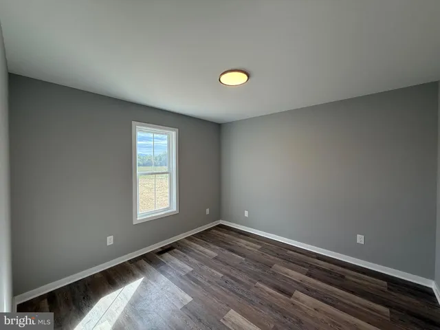 a bathroom with a granite countertop sink vanity and mirror