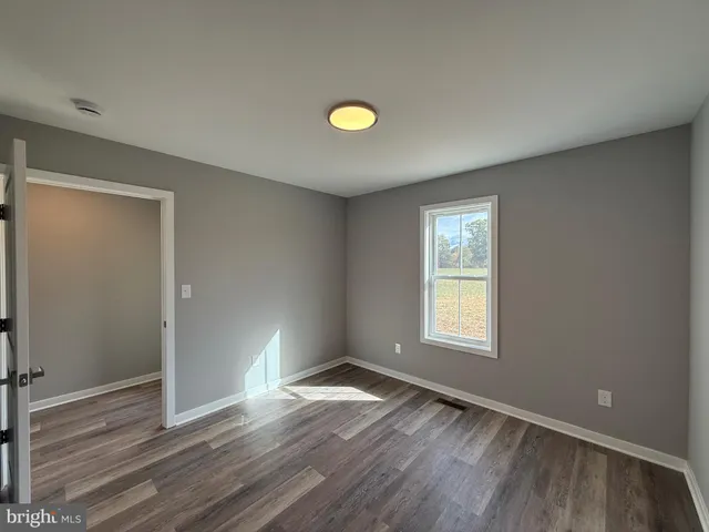 a view of an empty room and a window