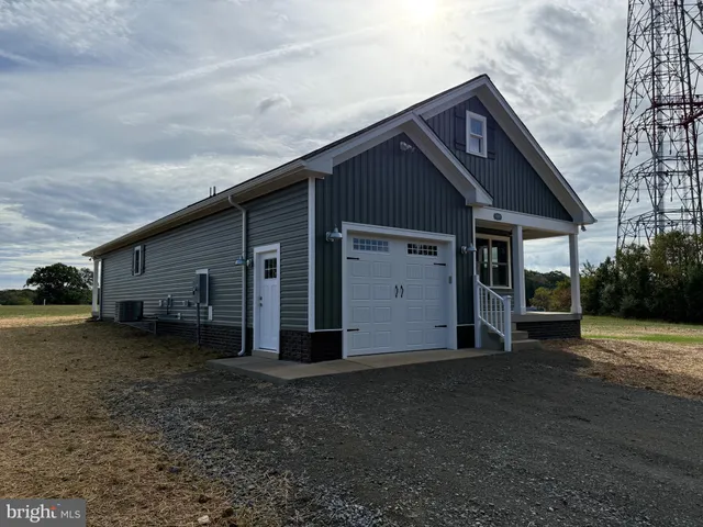 a front view of house with a garden