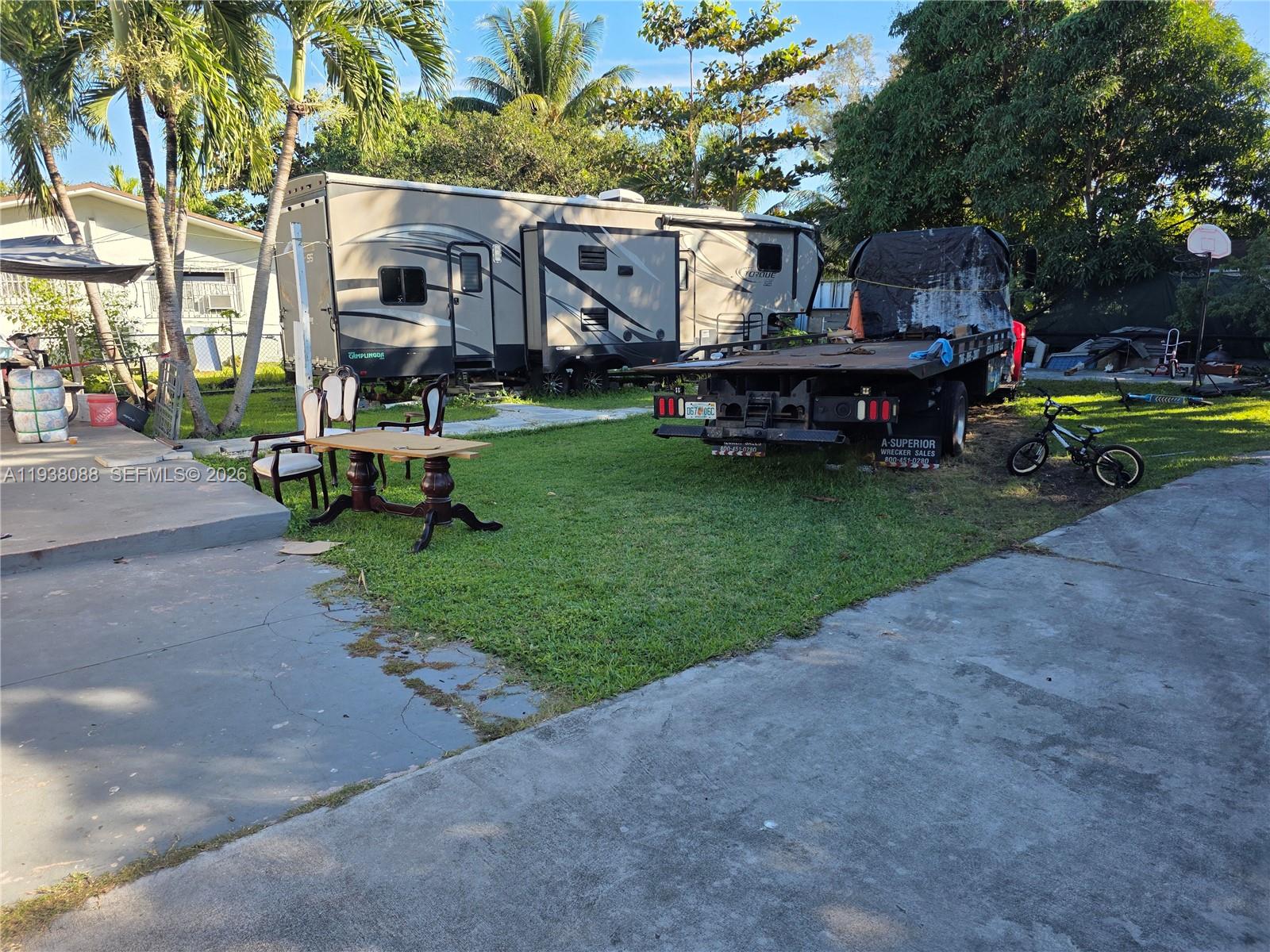 1490 Northeast 147th Street Miami, FL 33161 - Photo 3 of 9 a front view of a house with garden and sitting area