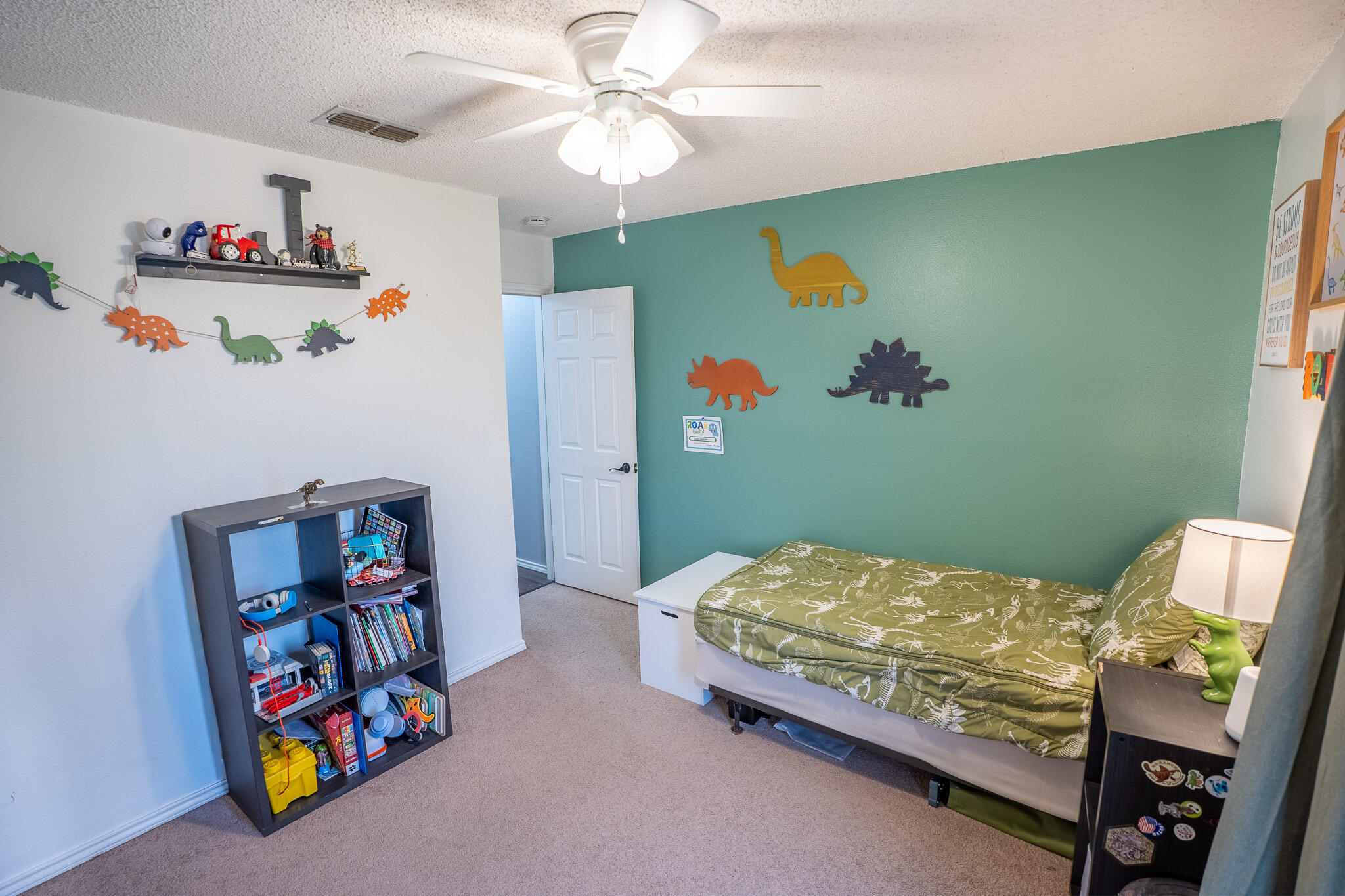 1609 78th Street Lubbock, TX 79423 - Photo 20 of 36 a bedroom with a bed and a chandelier