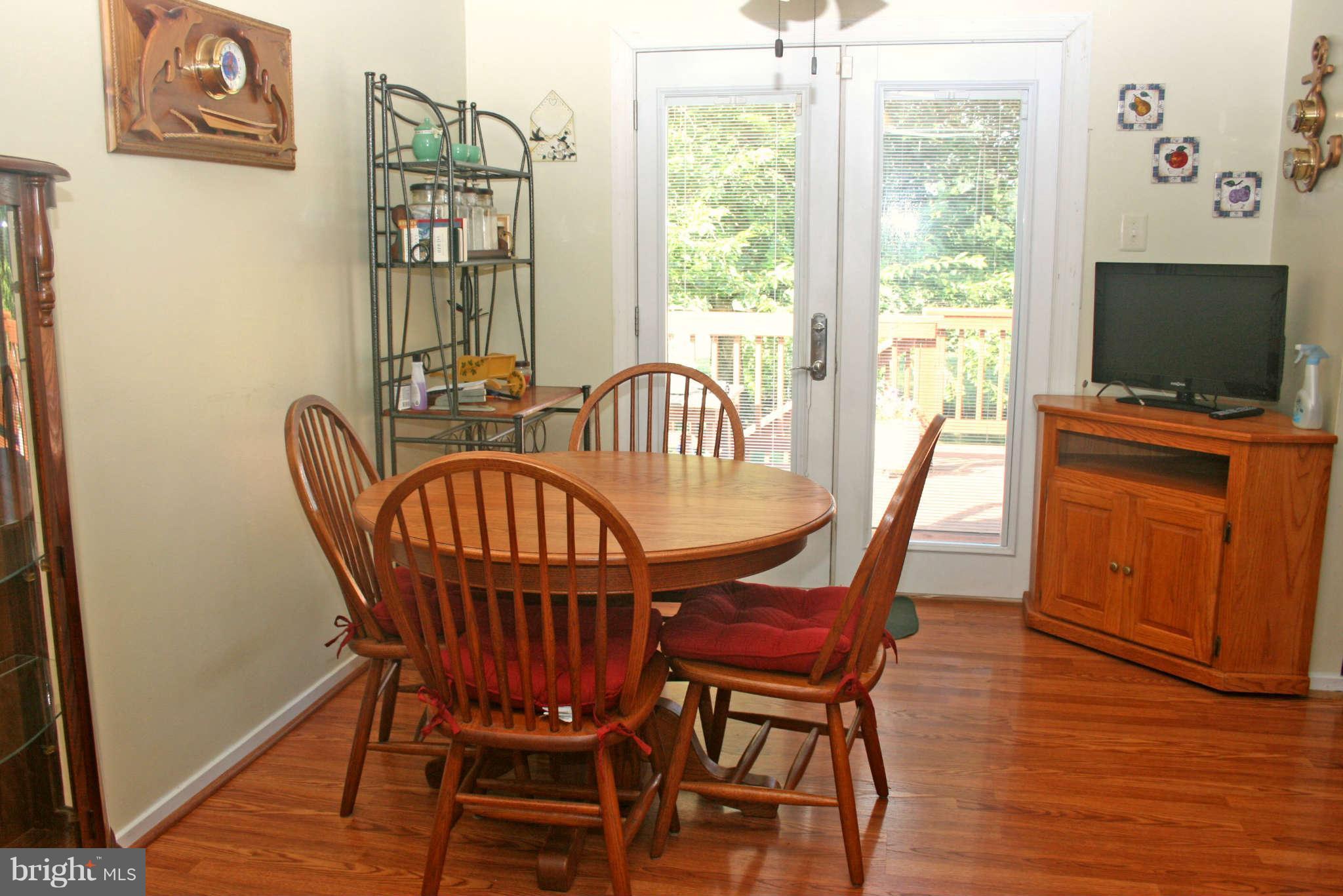 127 Cove Point Road Lusby, MD 20657 - Photo 9 of 27 Dining room has sliders to deck