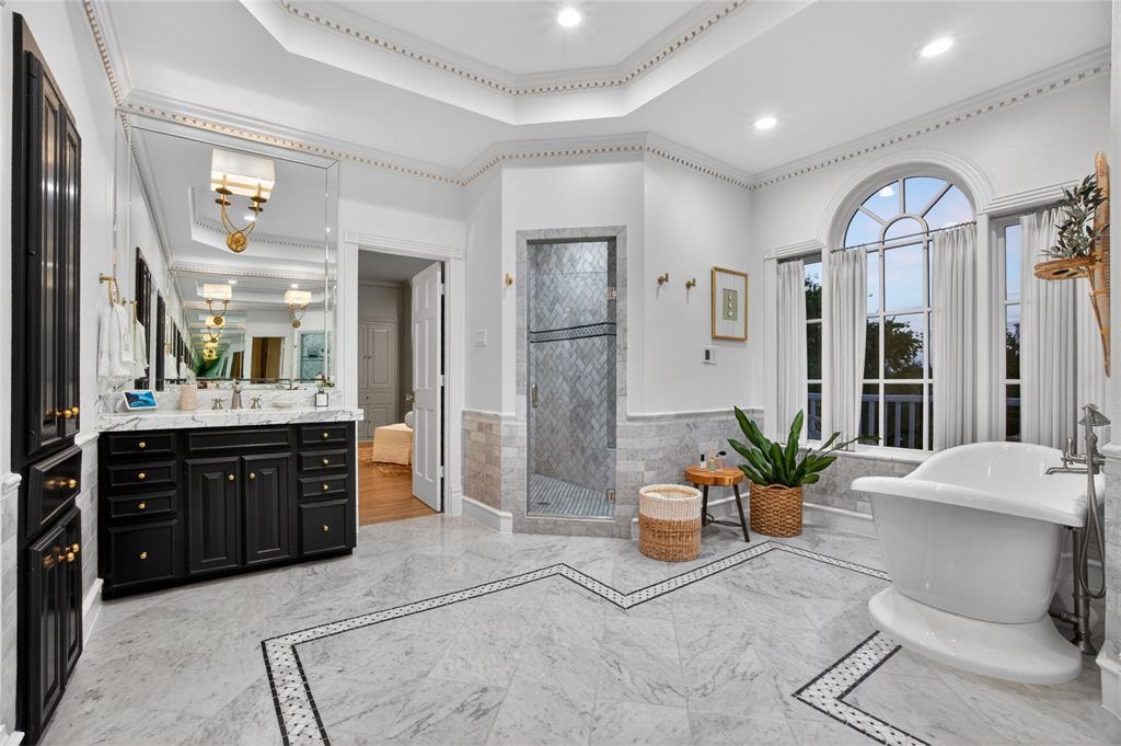 6331 Waggoner Drive Dallas, TX 75230 - Photo 19 of 36 a spacious bathroom with a tub shower and sink