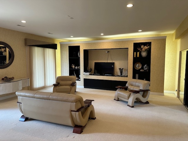21839 Riviera Court, Unit G Mundelein, IL 60060 - Photo 2 of 17 a living room with furniture gym equipment and a flat screen tv