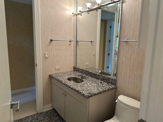21839 Riviera Court, Unit G Mundelein, IL 60060 - Photo 7 of 17 a bathroom with a granite countertop sink and a mirror