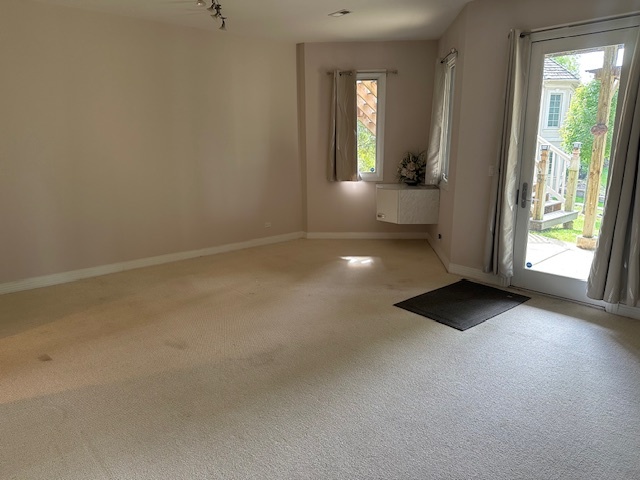 21839 Riviera Court, Unit G Mundelein, IL 60060 - Photo 9 of 17 wooden floor in an empty room with a window