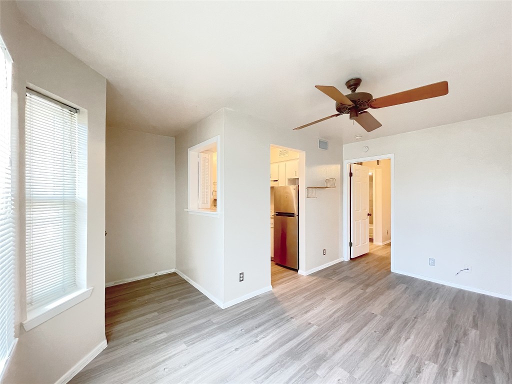 3400 Speedway, Unit 105 Austin, TX 78705 - Photo 4 of 18 a view of a livingroom with wooden floor and a ceiling fan