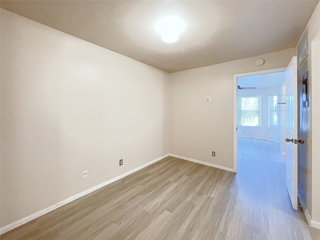 3400 Speedway, Unit 105 Austin, TX 78705 - Photo 10 of 18 an empty room with wooden floor and windows