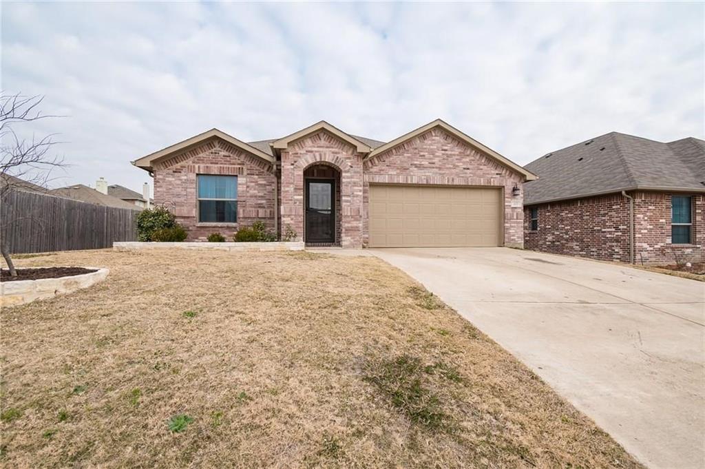 227 Timber Drive Princeton, TX 75407 - Photo 2 of 13 View of front facade with brick siding, concrete driveway, a shingled roof, and an attached garage