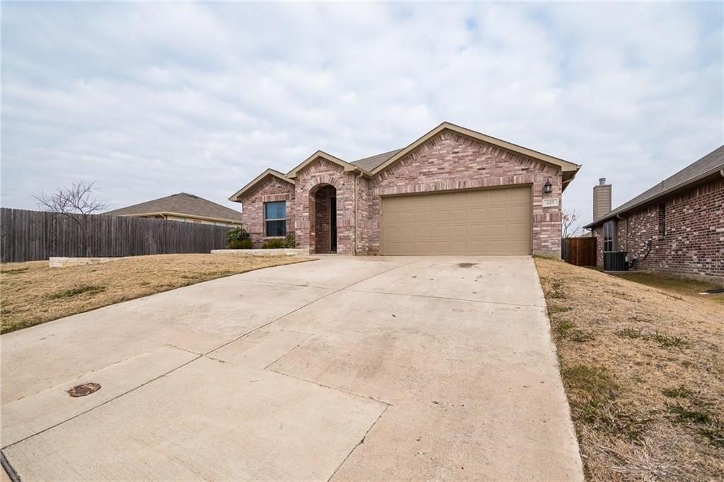 227 Timber Drive Princeton, TX 75407 - Photo 3 of 13 View of front of house with brick siding, concrete driveway, and a garage
