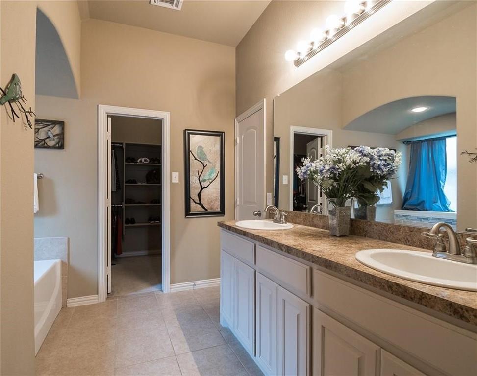 227 Timber Drive Princeton, TX 75407 - Photo 8 of 13 Full bath featuring double vanity, a garden tub, a walk in closet, and light tile patterned floors
