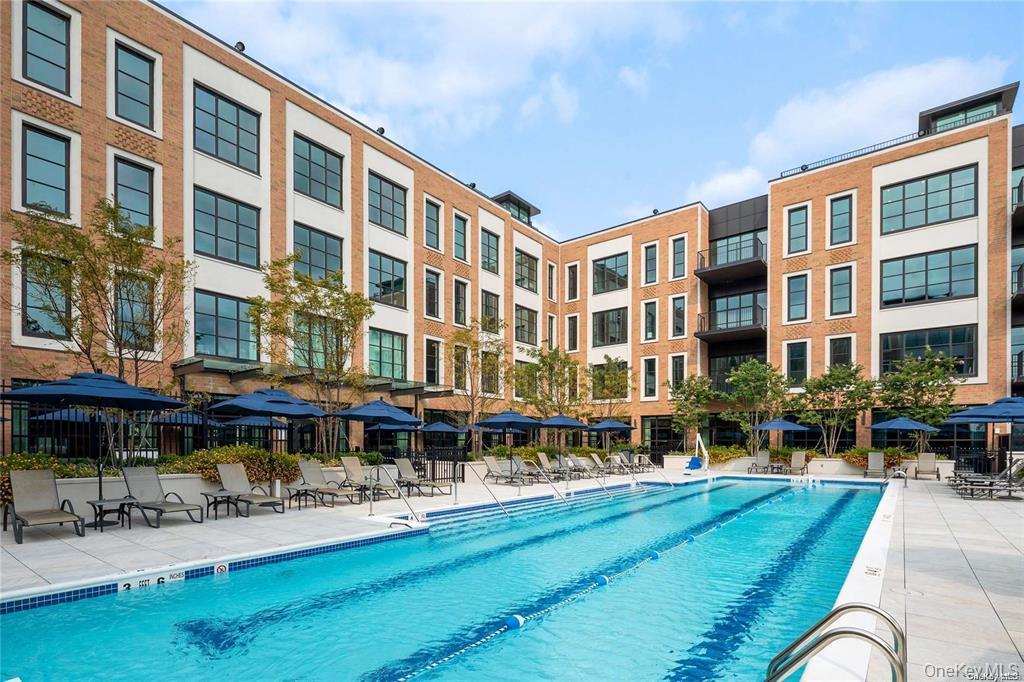 100 Garvies Point Road, Unit 1202 Glen Cove, NY 11542 - Photo 9 of 14 Community pool featuring a patio area