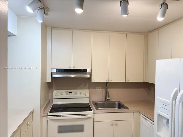 a kitchen with a stove and a refrigerator