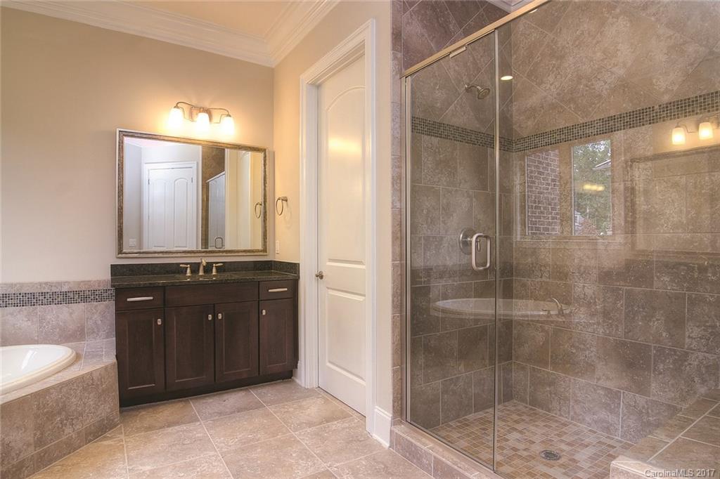160 Forsythia Lane, Unit 739 Tega Cay, SC 29708 - Photo 11 of 24 a bathroom with a bathtub shower sink mirror and toilet