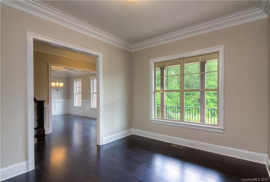 160 Forsythia Lane, Unit 739 Tega Cay, SC 29708 - Photo 3 of 24 an empty room with wooden floor and windows
