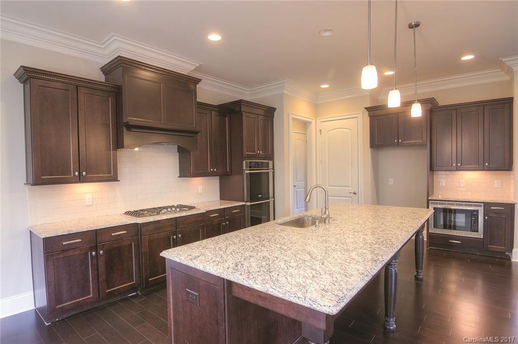 160 Forsythia Lane, Unit 739 Tega Cay, SC 29708 - Photo 7 of 24 a kitchen with a stove a refrigerator and a sink