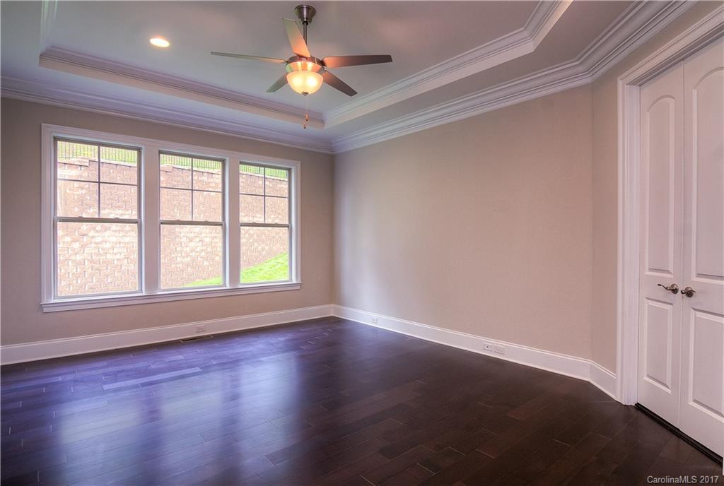160 Forsythia Lane, Unit 739 Tega Cay, SC 29708 - Photo 9 of 24 an empty room with wooden floor and windows