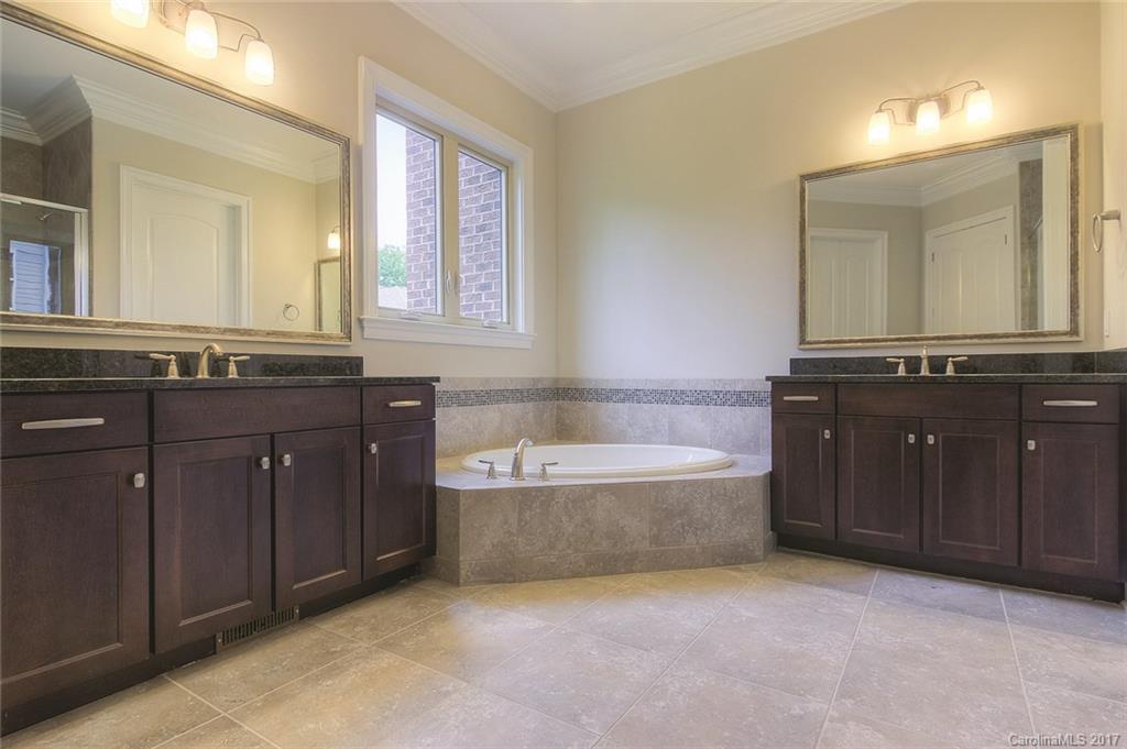 160 Forsythia Lane, Unit 739 Tega Cay, SC 29708 - Photo 10 of 24 a spacious bathroom with a tub sink and mirror