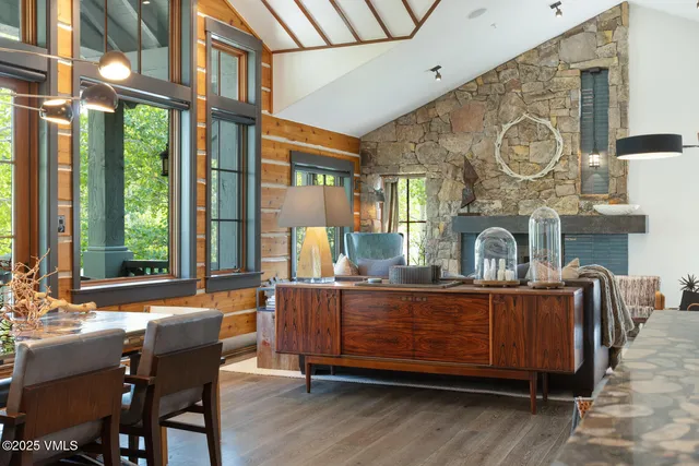 a living room with fireplace furniture and a large window