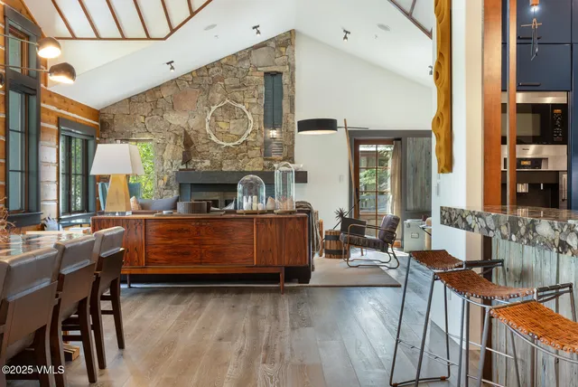 a living room with furniture a fireplace and a table