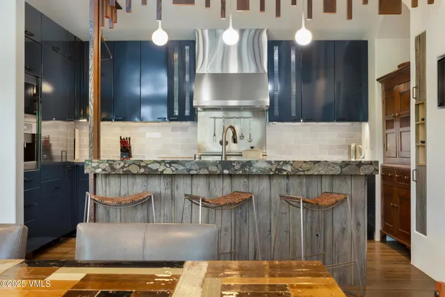 a kitchen with kitchen island granite countertop wooden cabinets and a counter top space
