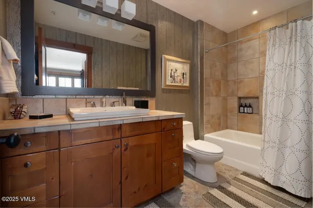 a view of walk in closet and bathroom