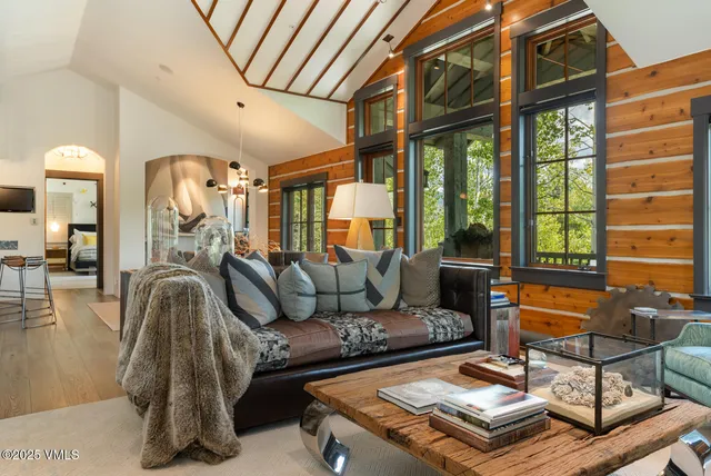a living room with furniture and a floor to ceiling window