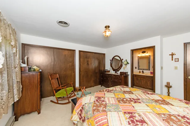 a bedroom with bed and a large mirror