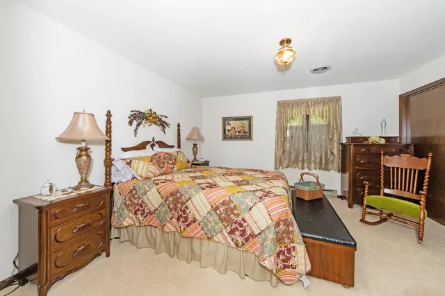 a bedroom with bed and window