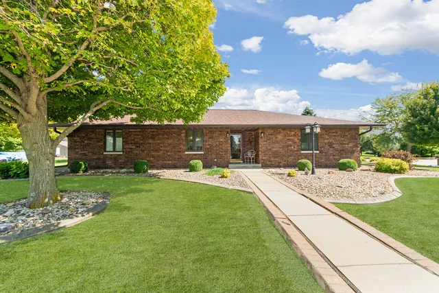 a view of a house with backyard and sitting area