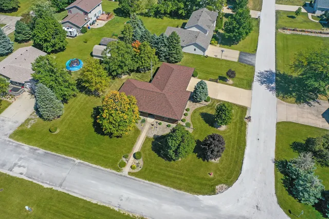 an aerial view of a residential houses with outdoor space