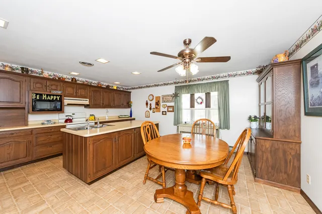 a kitchen with stainless steel appliances granite countertop a sink a stove and a refrigerator