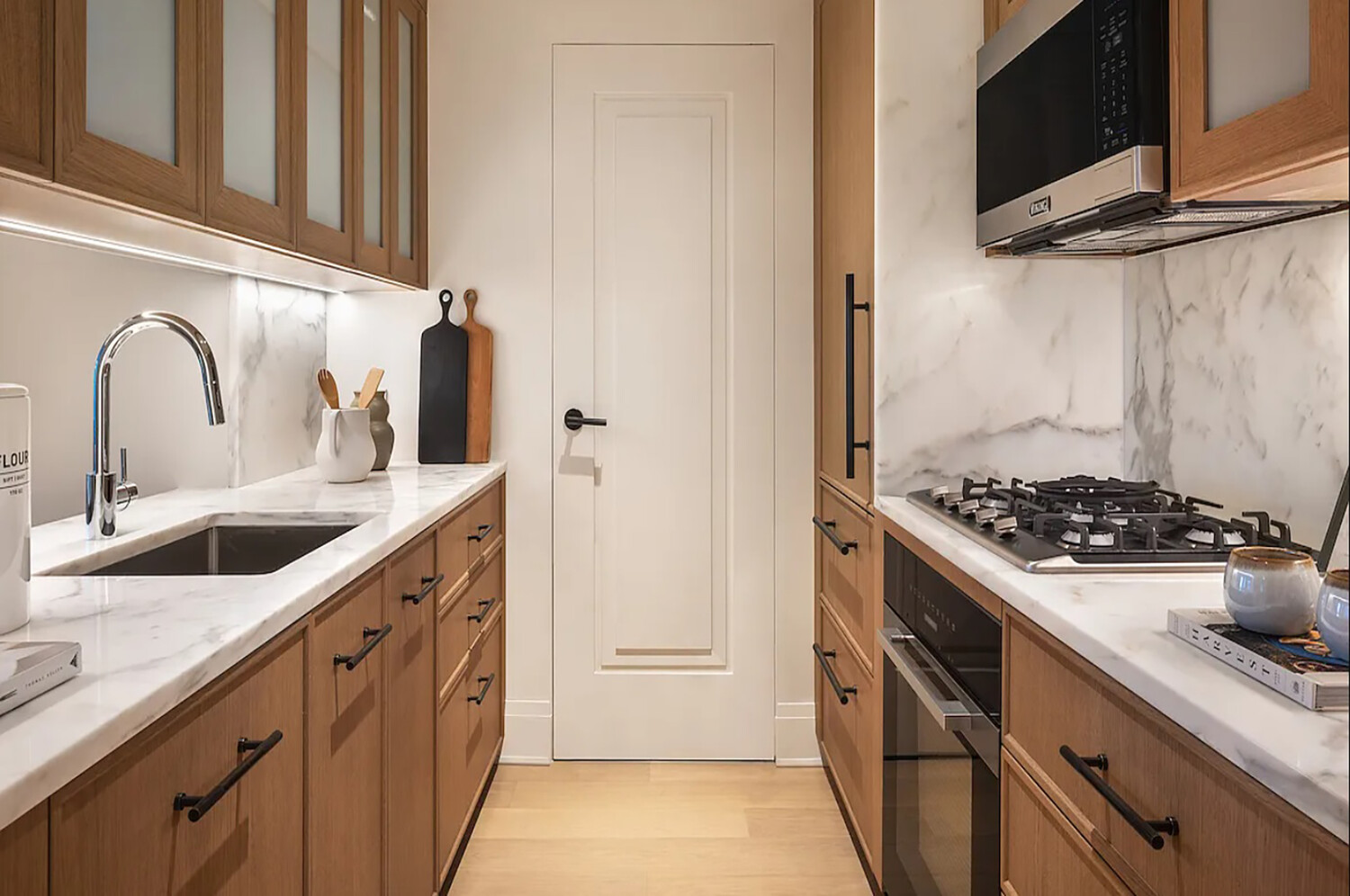 210 Warren Street, Unit 9G Manhattan, NY 10282 - Photo 3 of 11 a kitchen with stainless steel appliances a sink and a stove