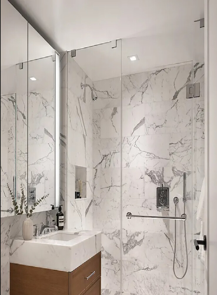 210 Warren Street, Unit 9G Manhattan, NY 10282 - Photo 5 of 11 a bathroom with a sink and a mirror