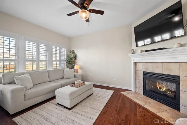a living room with furniture a flat screen tv and a fireplace