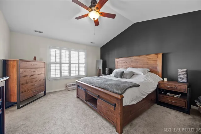 a spacious bedroom with a bed and a chandelier