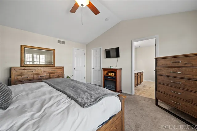 a bedroom with a bed and a television