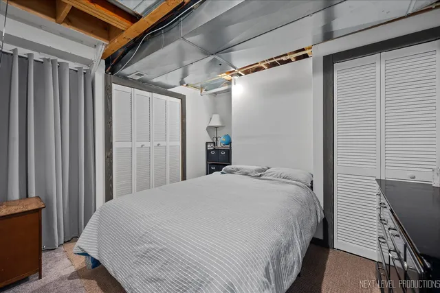 a bed sitting in a bedroom next to a window