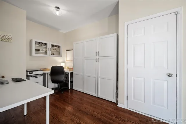 a view of a workspace with furniture and wooden floor