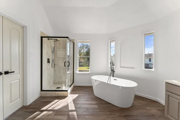 a bathroom with a bathtub and shower