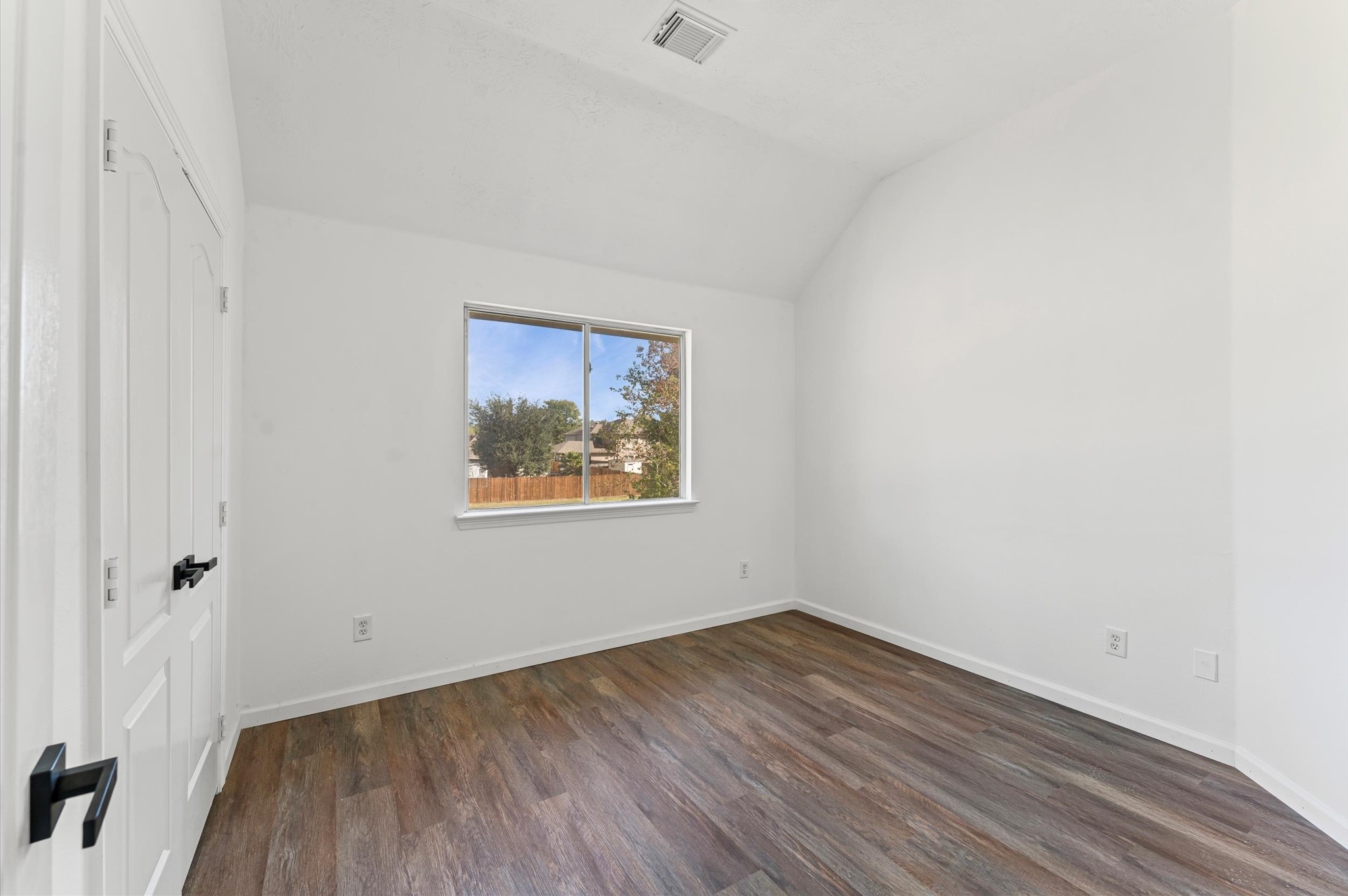 2830 Fern Hill Drive Spring, TX 77373 - Photo 16 of 22 a view of an empty room with wooden floor and a window
