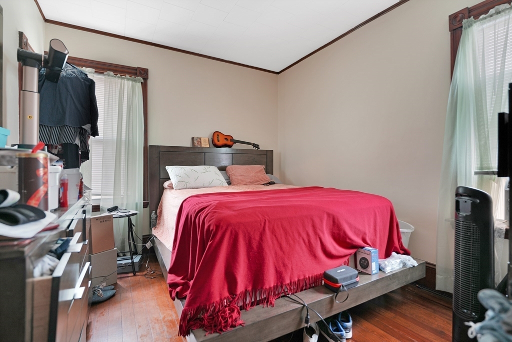 135-137 Query Street New Bedford, MA 02745 - Photo 4 of 17 a bed sitting in a bedroom next to a window