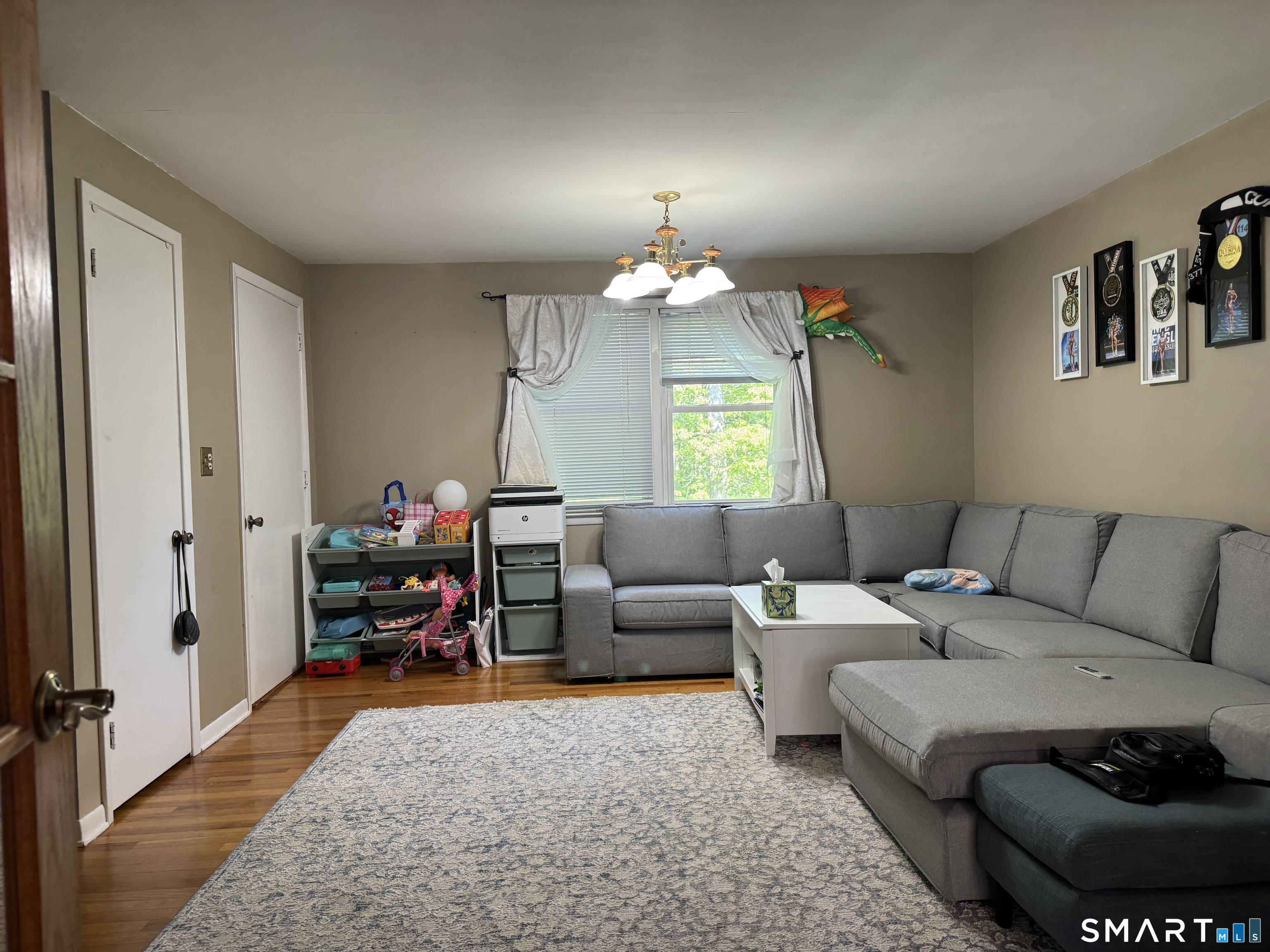 480 Radmere Road, Unit B Cheshire, CT 06410 - Photo 7 of 13 a living room with furniture and a chandelier