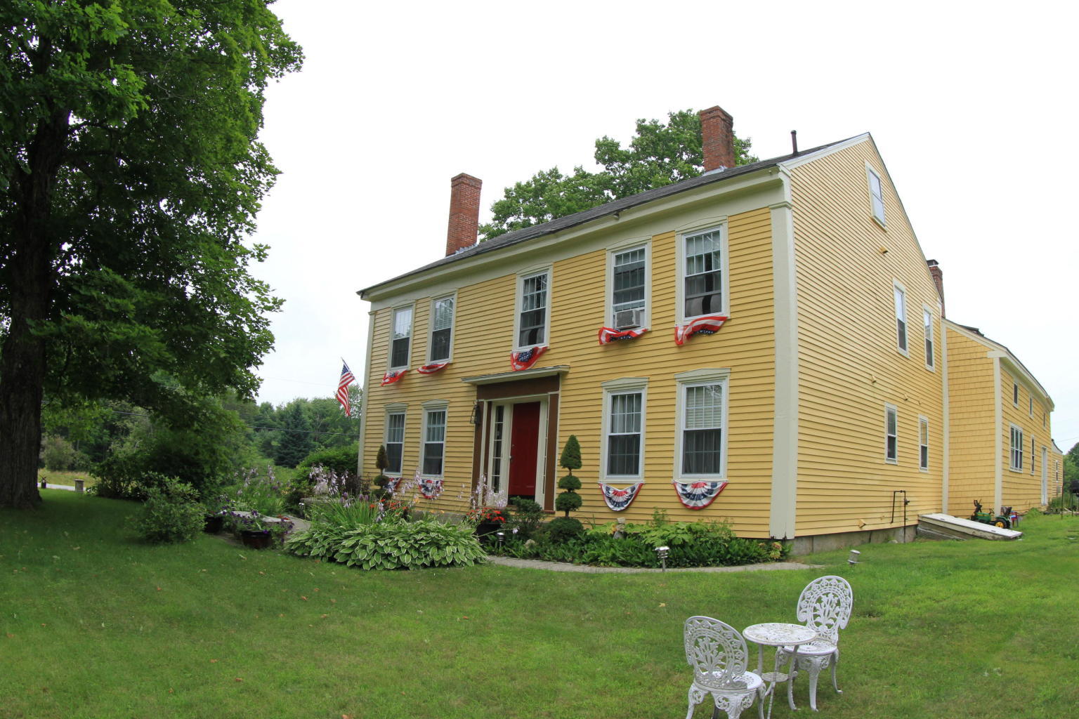 1290 Royalsborough Road Durham, ME 04222 - Photo 2 of 64 front with flags and table