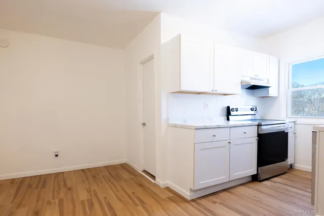 a kitchen with sink cabinets and wooden floor