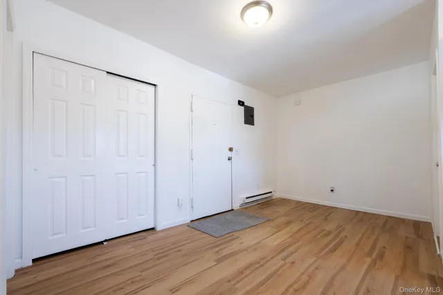 a view of a room with wooden floor
