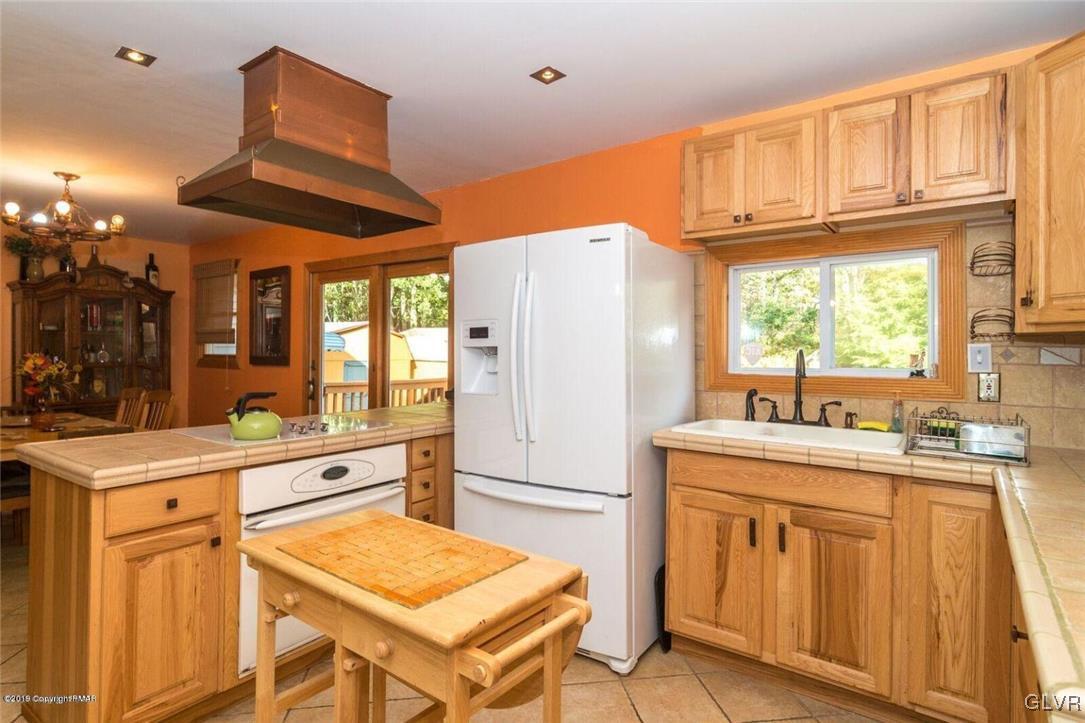 2841 Jackson Road Stroudsburg, PA 18360 - Photo 8 of 45 a kitchen with stainless steel appliances granite countertop a refrigerator a sink dishwasher and white cabinets with wooden floor