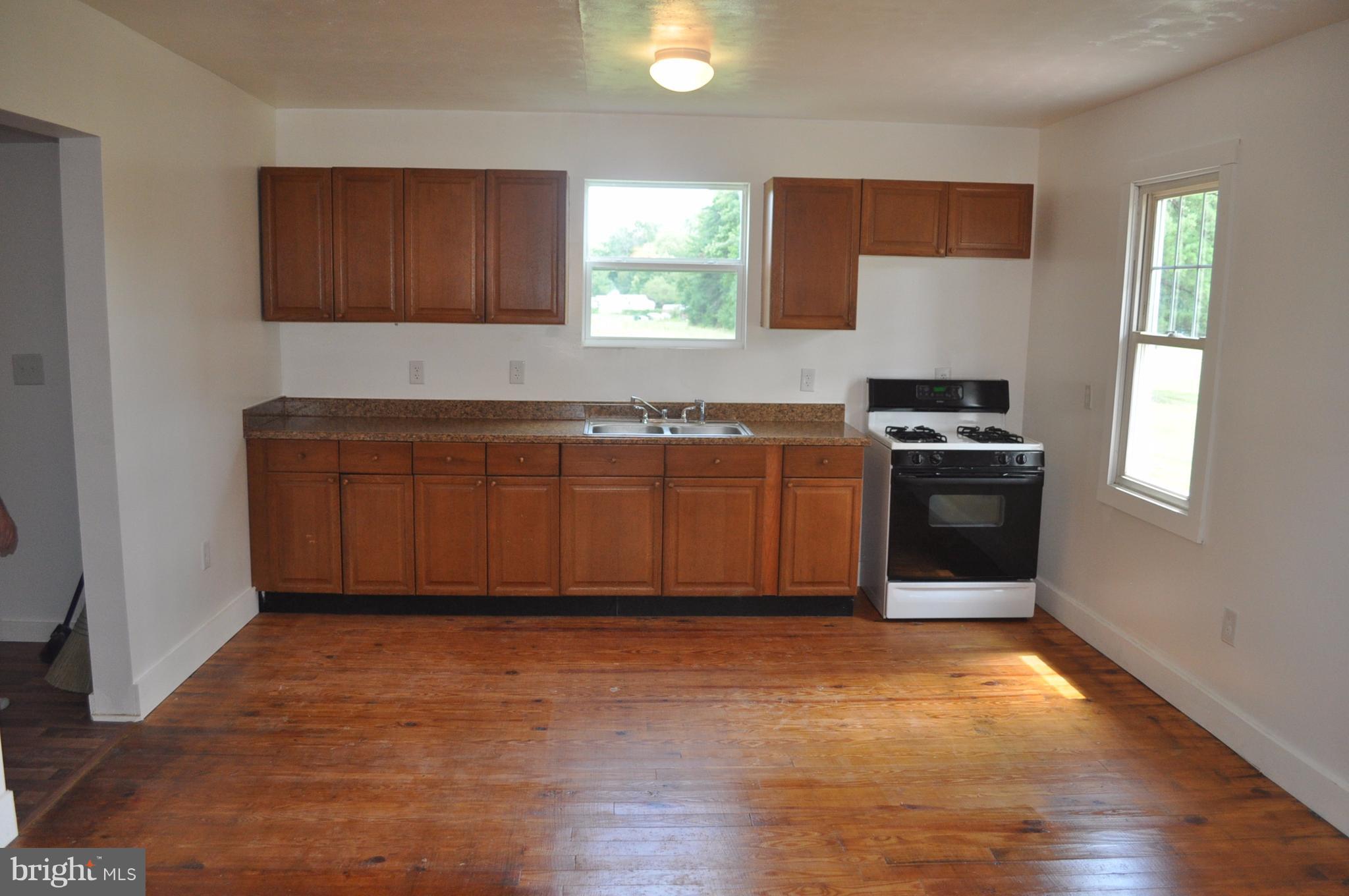 2263 Pomona Road Colonial Beach, VA 22443 - Photo 14 of 28 a kitchen with stainless steel appliances granite countertop a stove a sink and a refrigerator