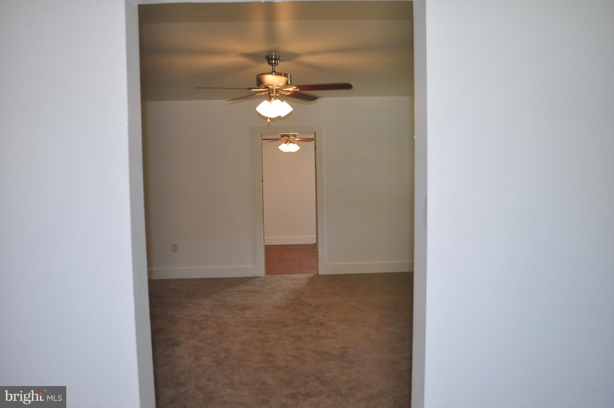 2263 Pomona Road Colonial Beach, VA 22443 - Photo 18 of 28 an empty room with a chandelier fan and closet