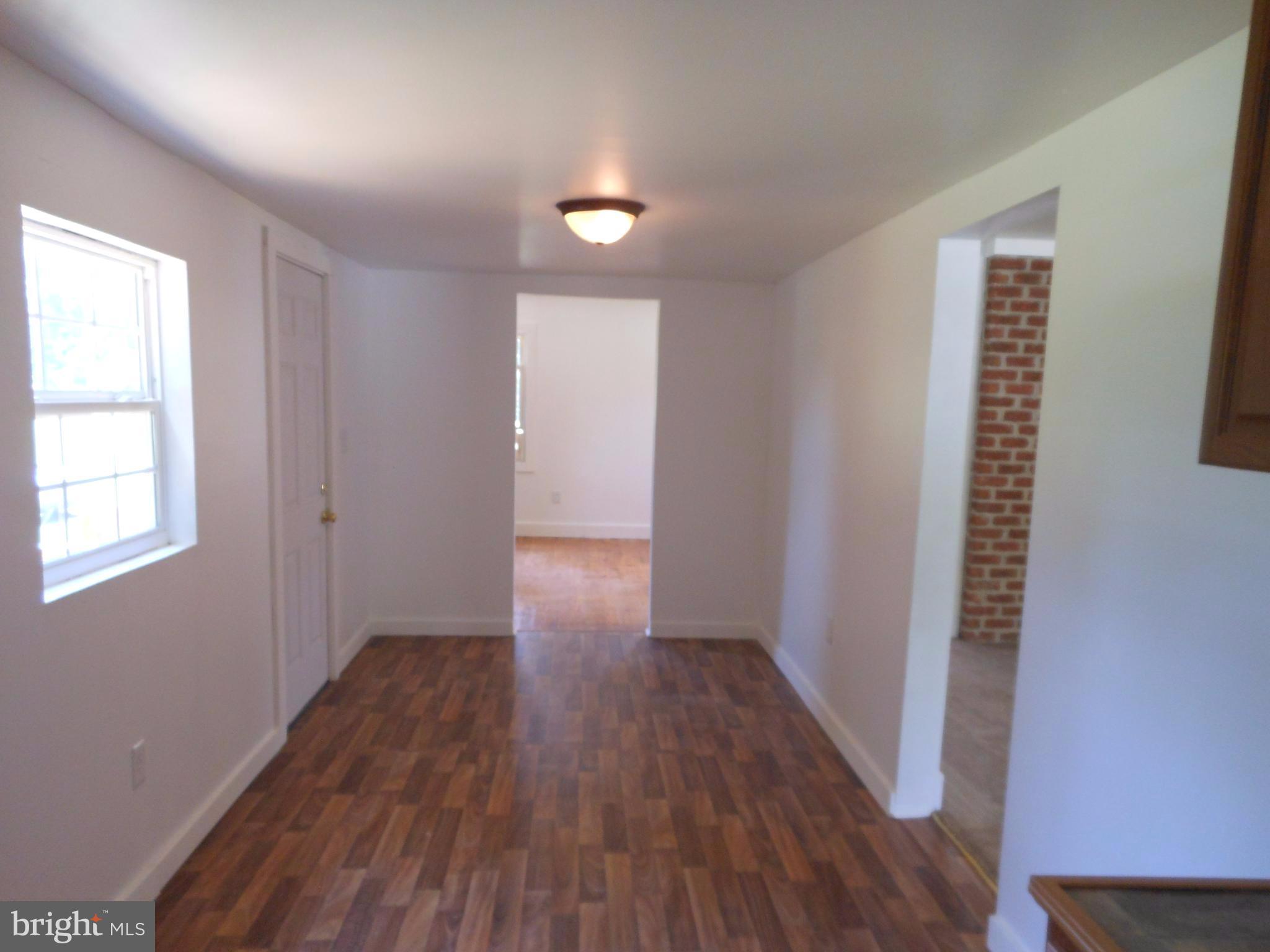 2263 Pomona Road Colonial Beach, VA 22443 - Photo 20 of 28 wooden floor in an empty room with a window